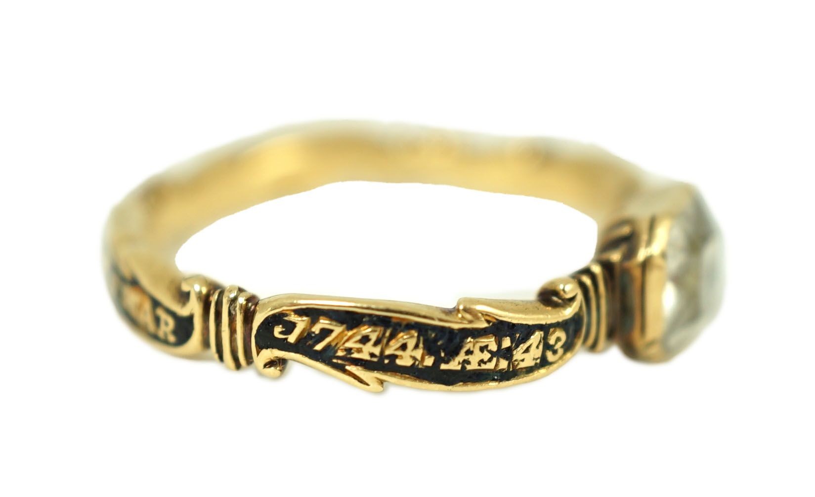 A George II gold, black enamel and rock crystal set mourning ring